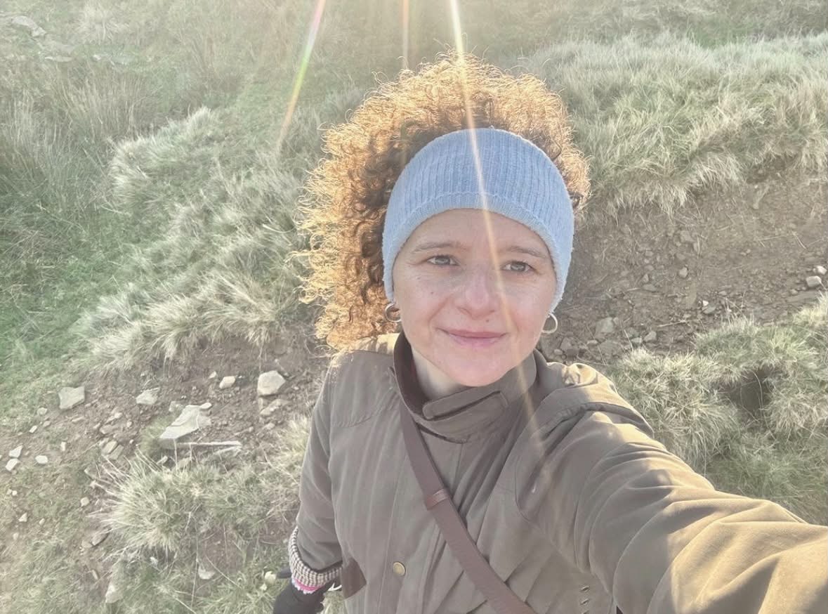 Paulina, Mindset & Transformational Coach, smiling outdoors at golden hour